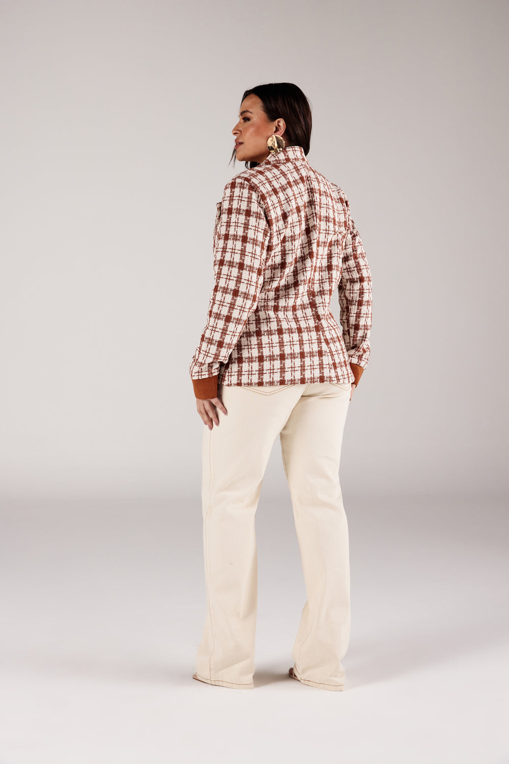 Calça reta jeans off white modelagem Curves, vista traseira com blazer xadrez Onça Preta