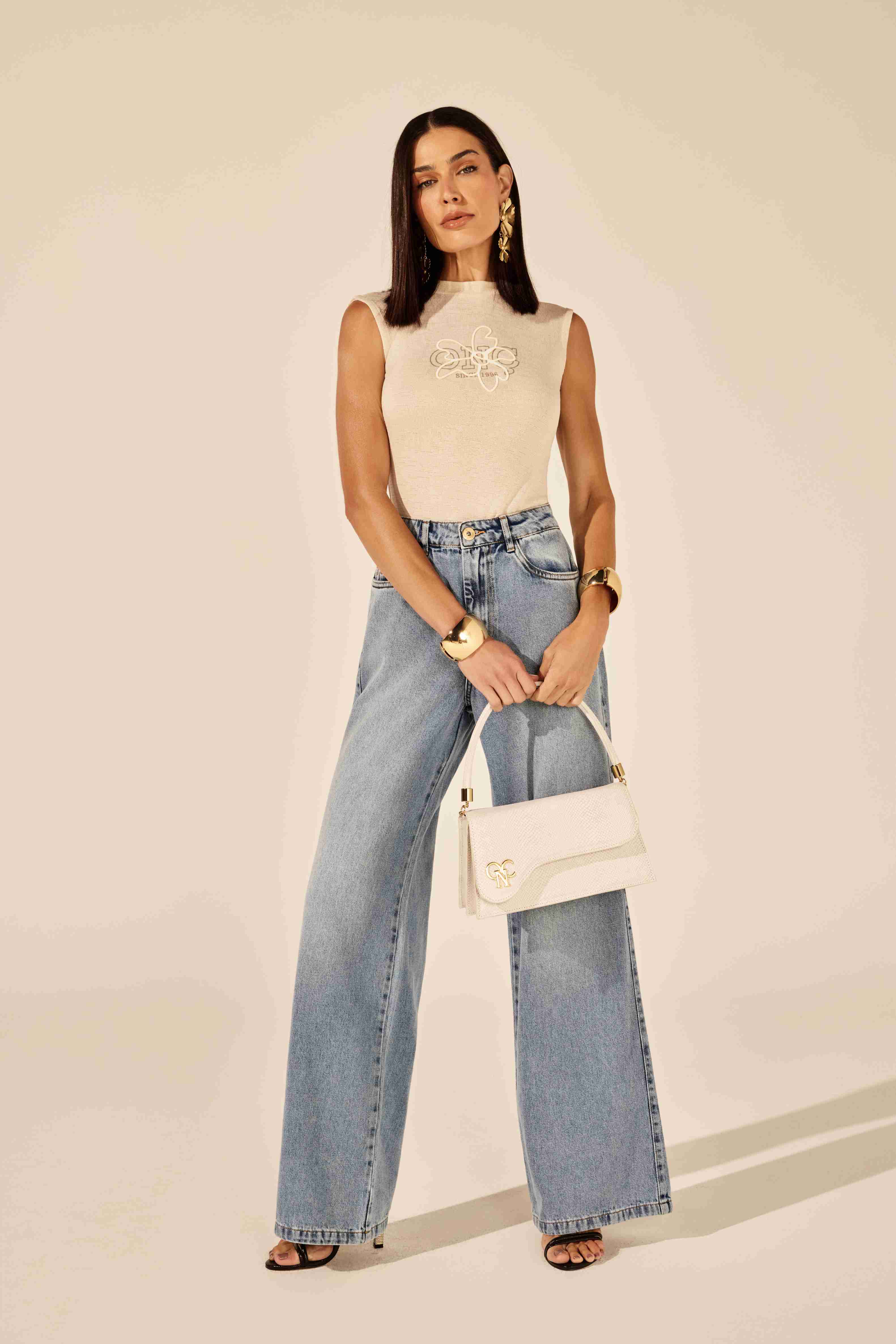 Calça wideleg bordado bolso relógio azul - modelo posando em ambiente urbano com atitude forte Onça Preta
