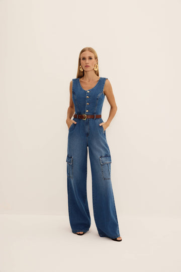 Macacão jeans reto azul regata com botões dourados, bolsos cargo e perna ampla, vista de frente com cinto