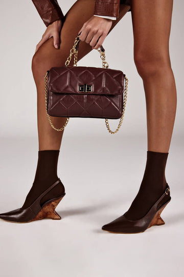 Bolsa feminina matelasse alça corrente vinho fecho dourado Onça Preta